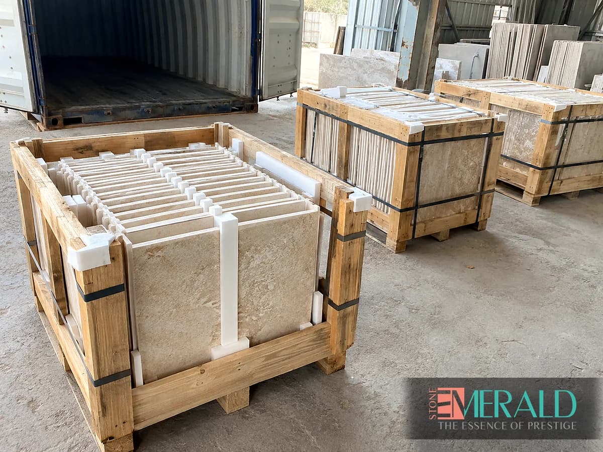 Wooden stone crates with separators and straps beside a shipping container — Emerald Stone