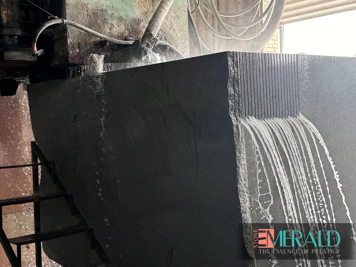 Back of a dark stone panel with grooves and adhesive marks